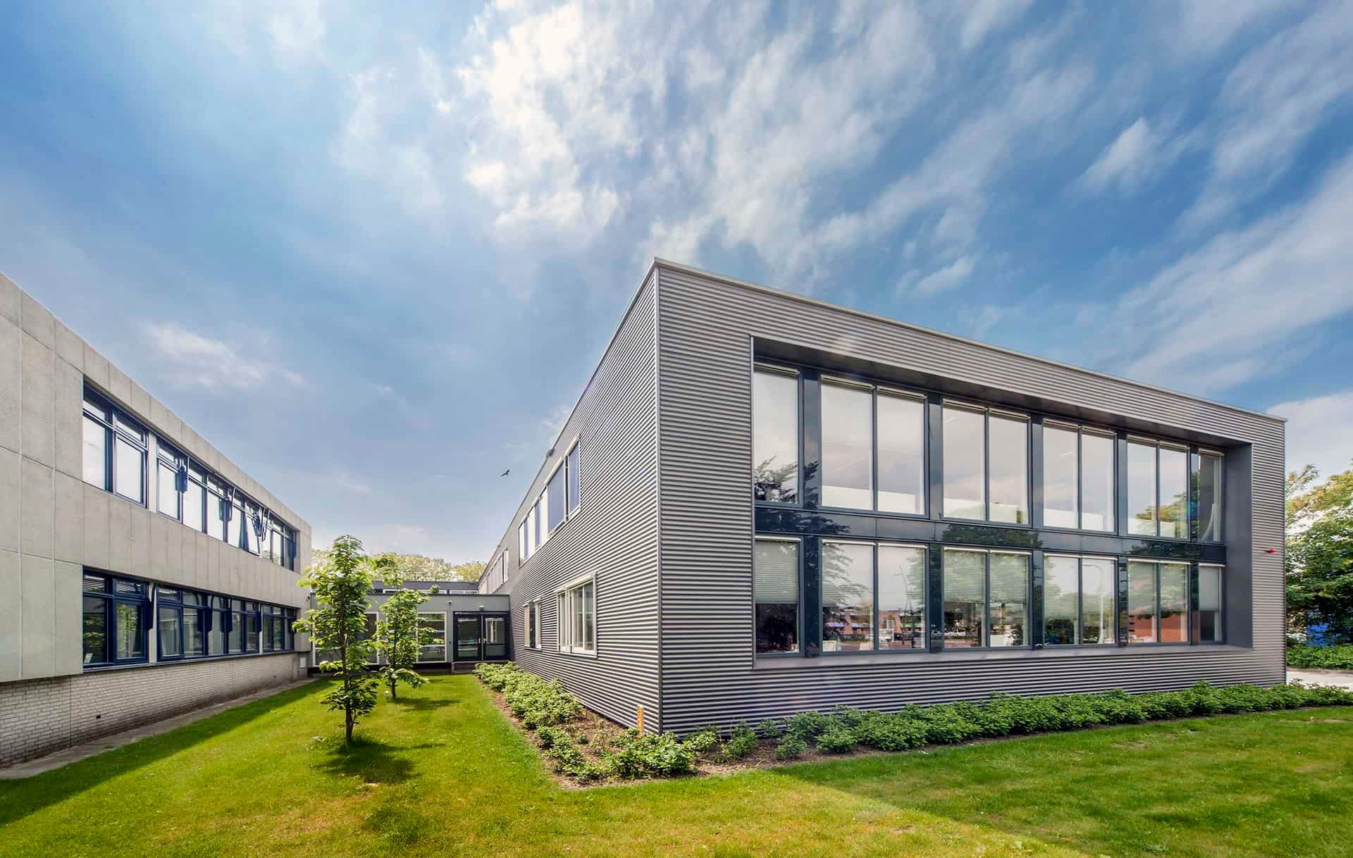 Het tijdelijke gemeentehuis in Middelharnis met gras en planten ervoor