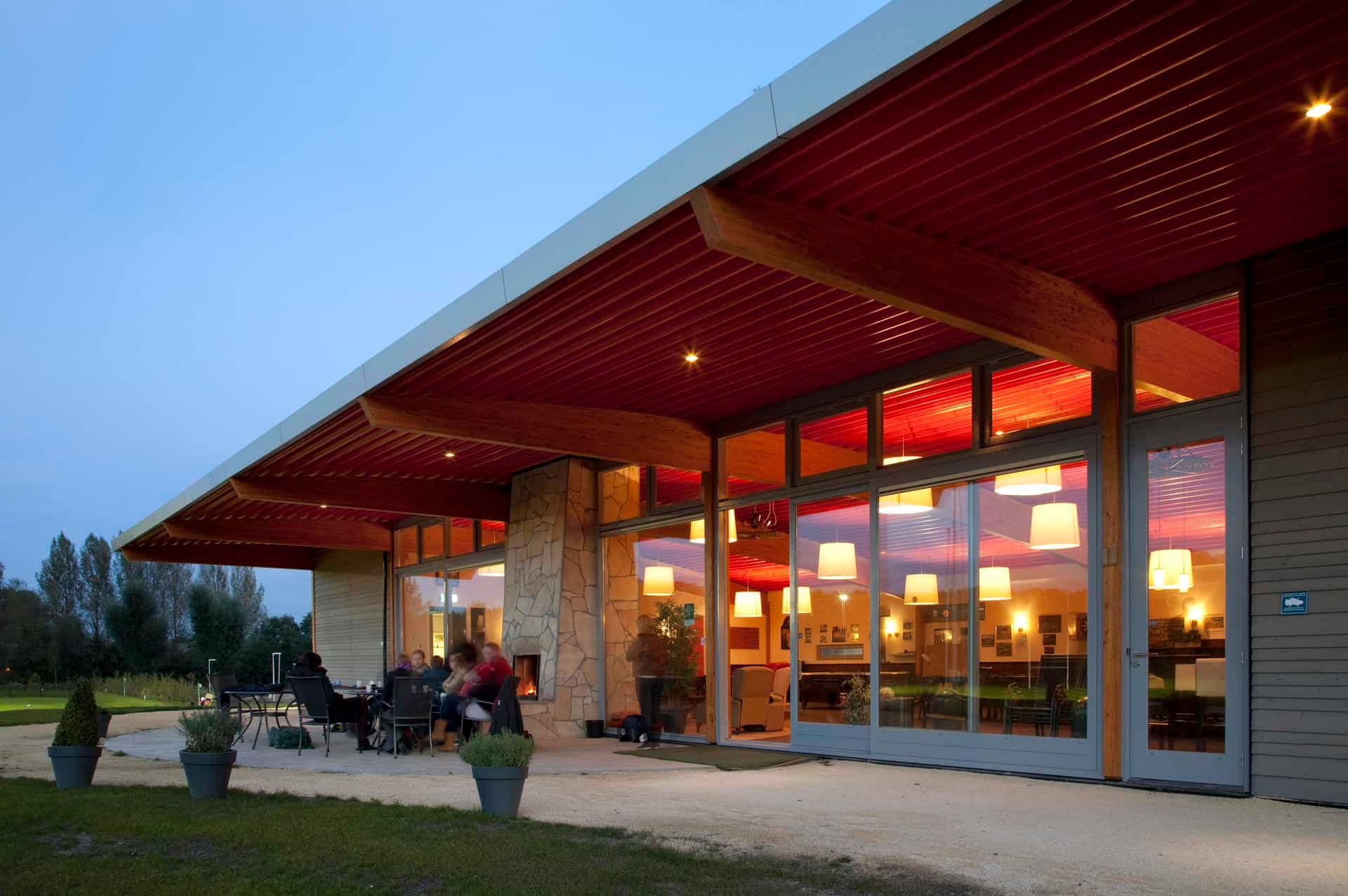 Gebouw in avondlicht met rood licht en groen gras